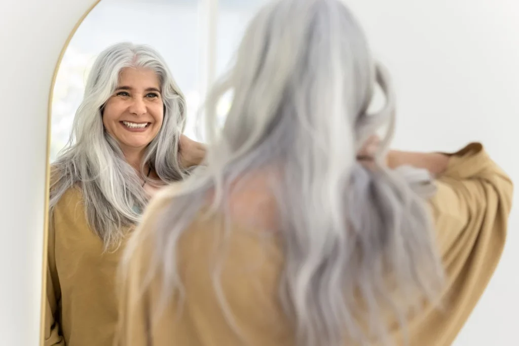 Old woman smiling in the mirror